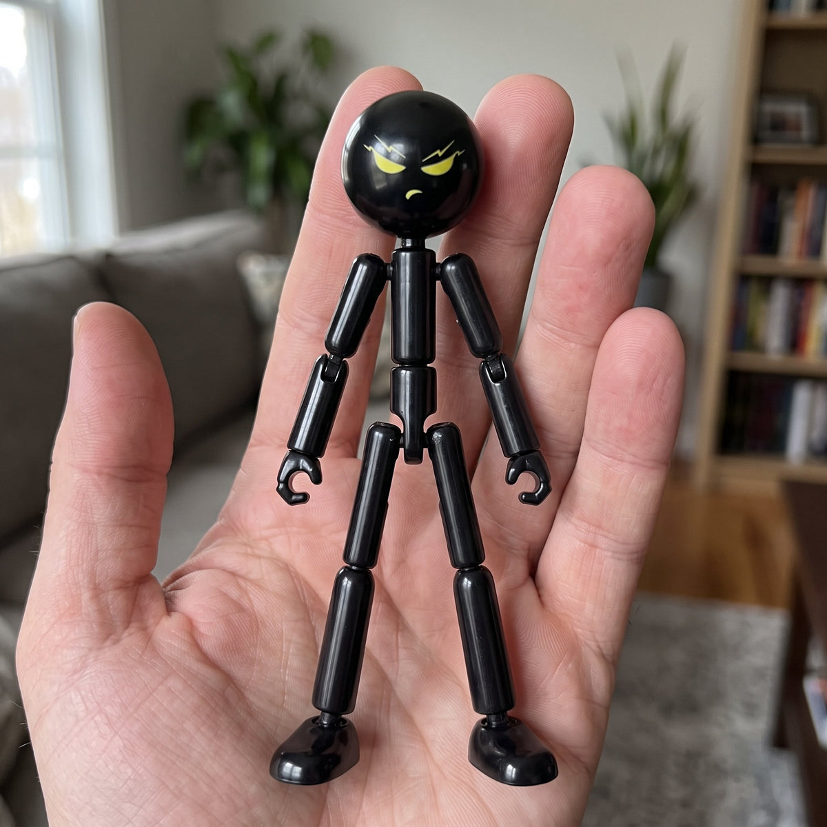 StickSquad Stickman Action Figure held in an adult hand for scale