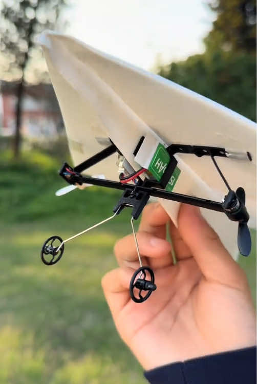 RC paper airplane flying in open outdoor area