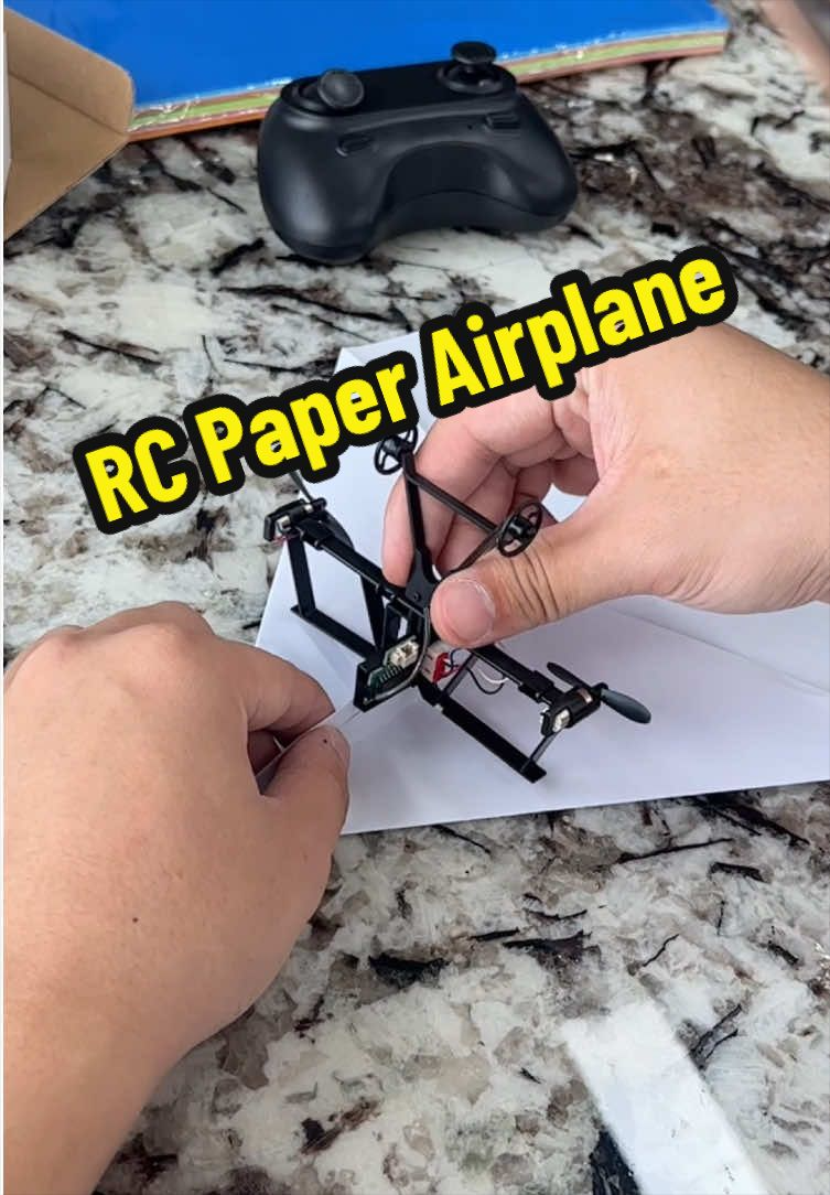 Kid folding a paper airplane before RC flight