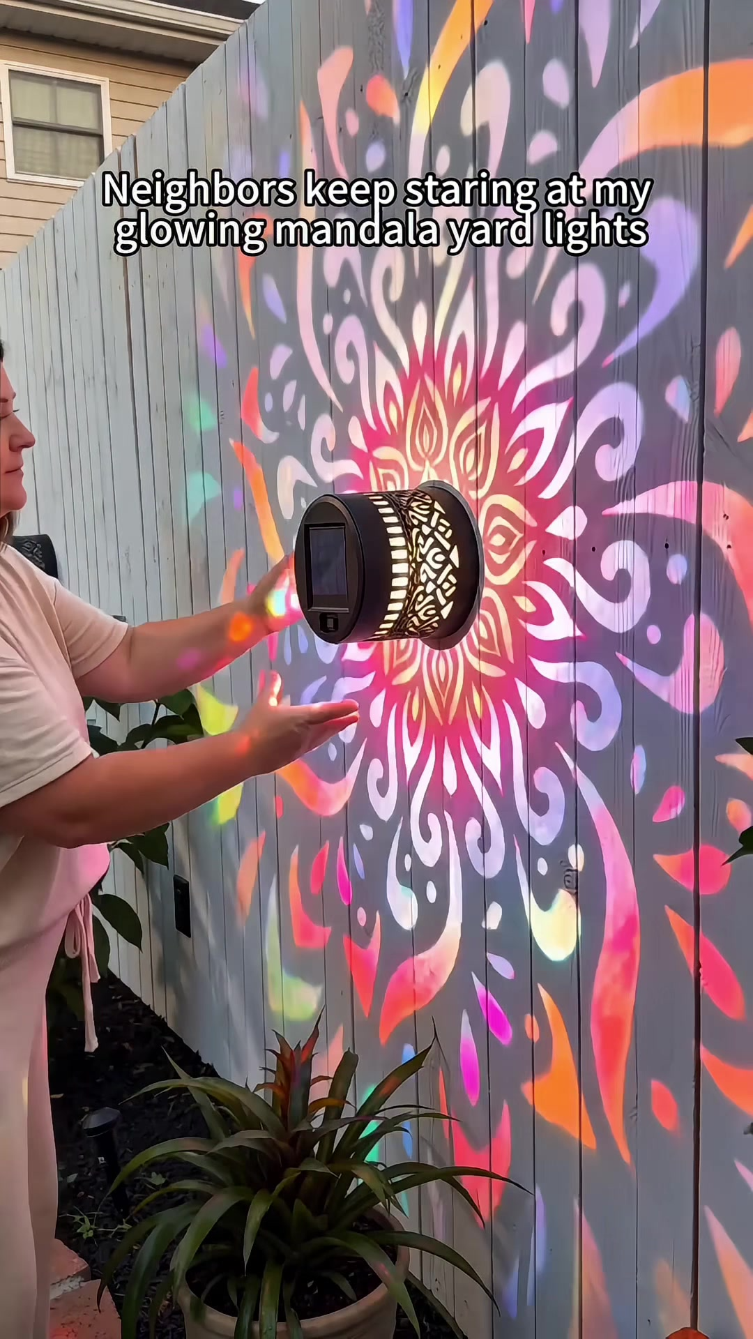 Solar mandala wall light installation on patio wall