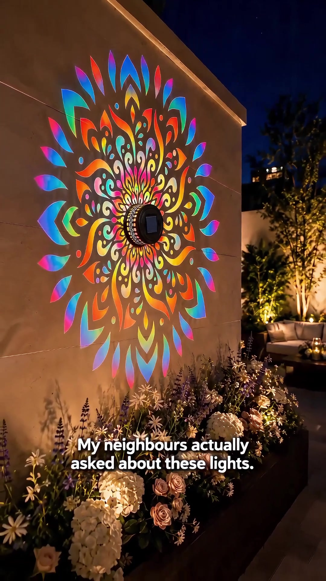 Solar mandala light on backyard wall at night