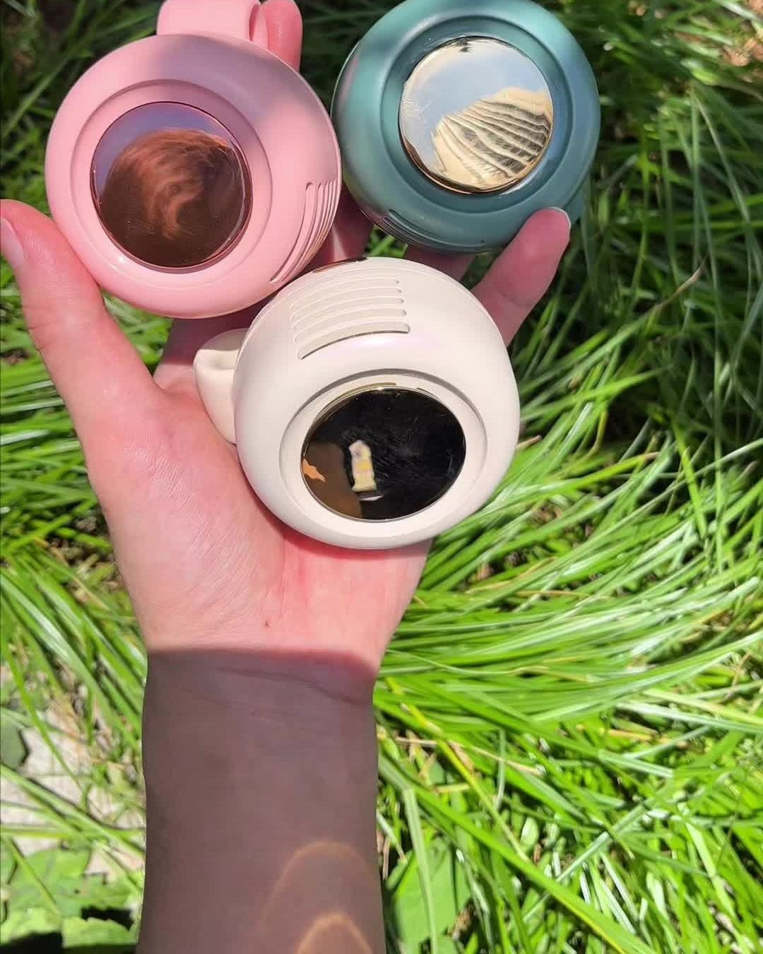 Customer holding three clip fans outdoors